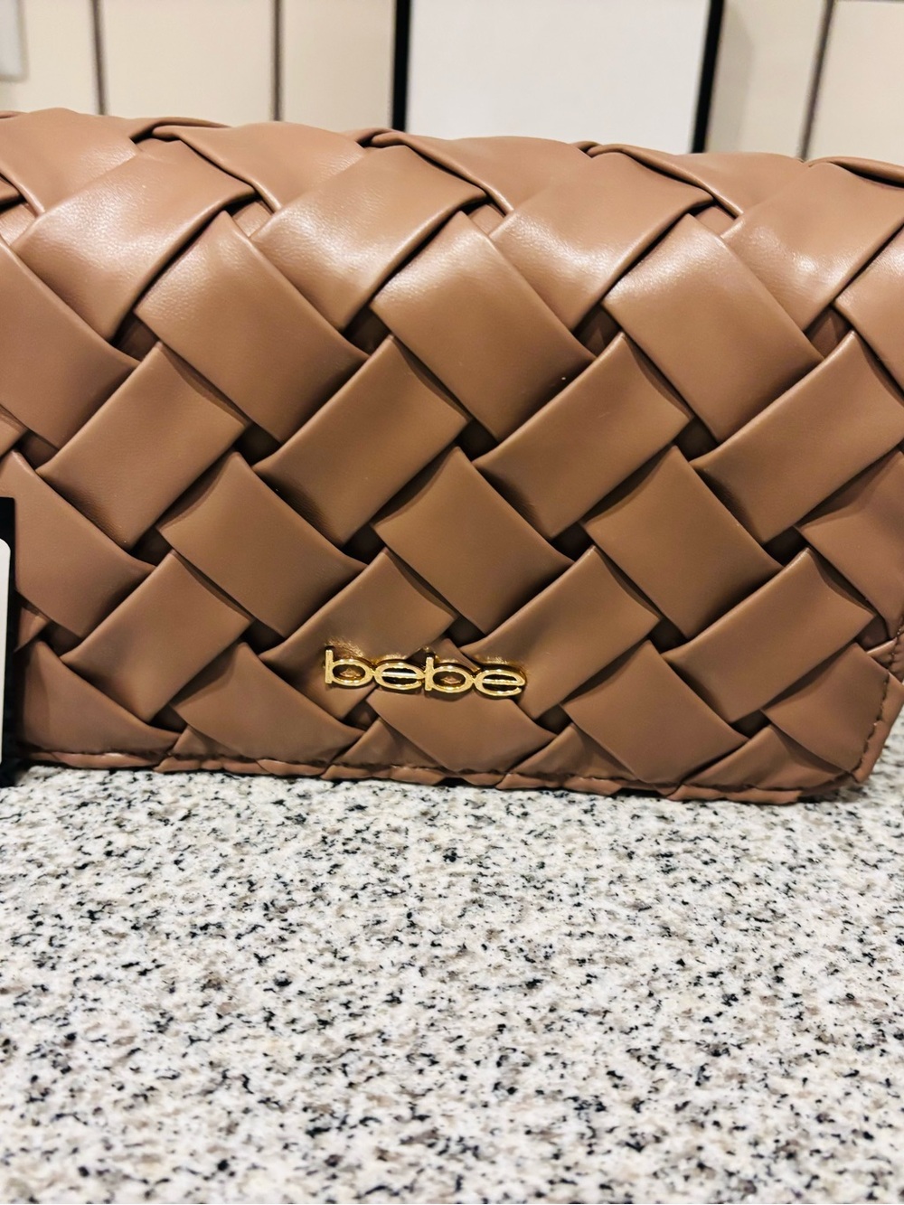 bebe Woven Clutch in Brown with Gold Logo
